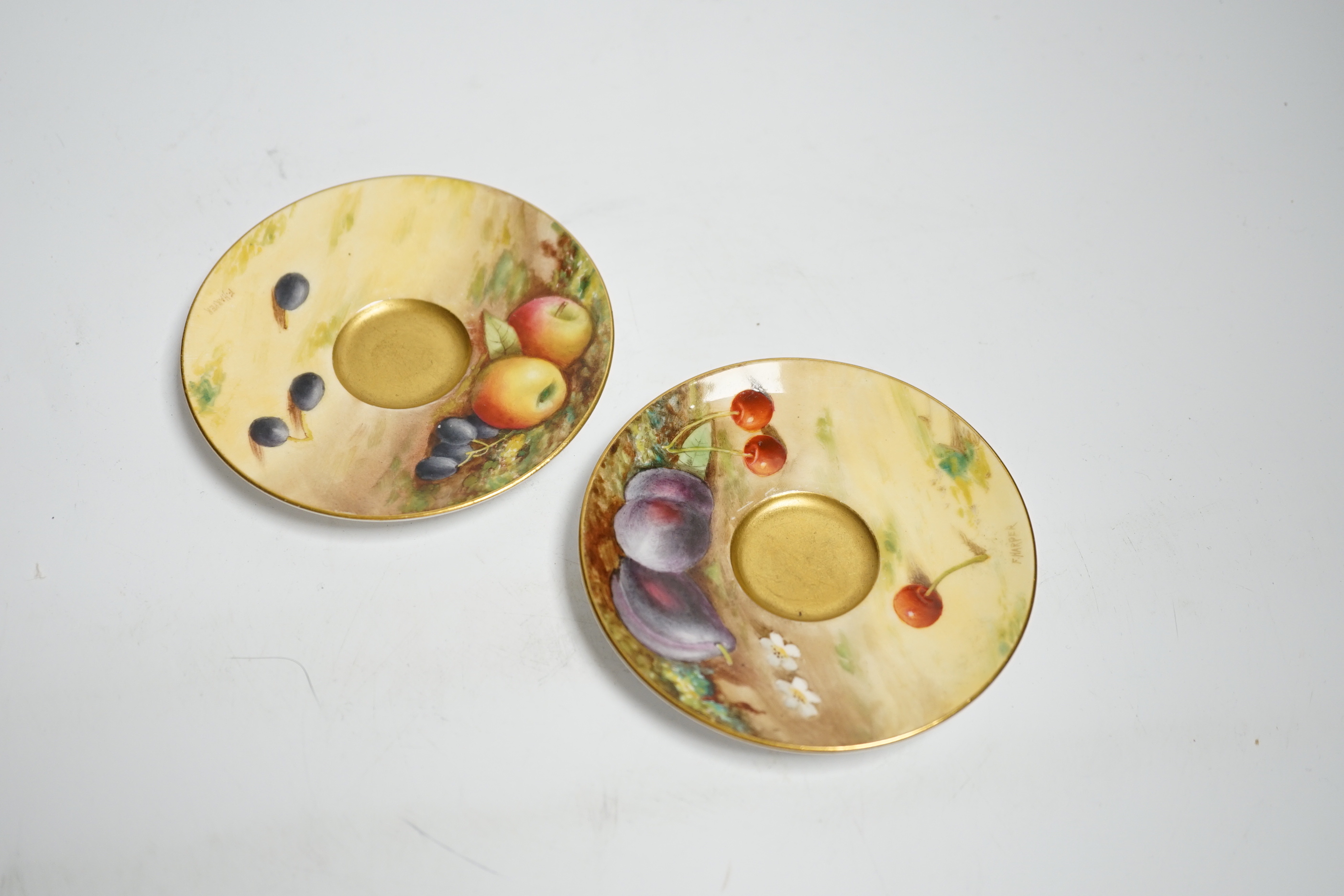 A pair of Royal Worcester fruit painted miniature cabinet cups and saucers, signed F. Harper and W.H. Austin